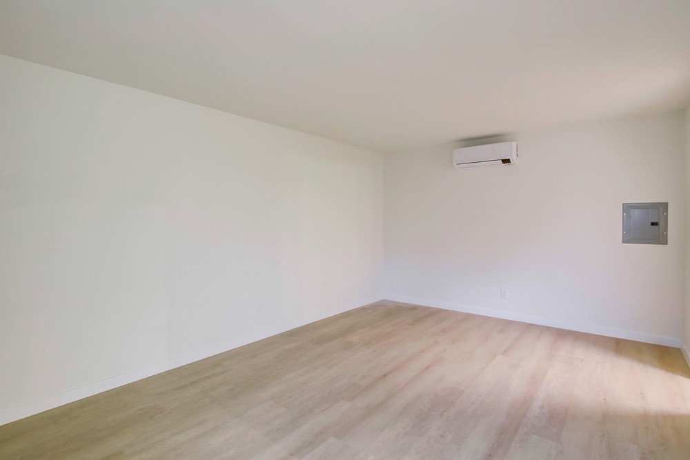 Vacant bedroom with wide-plank flooring and ductless mini-split A/C